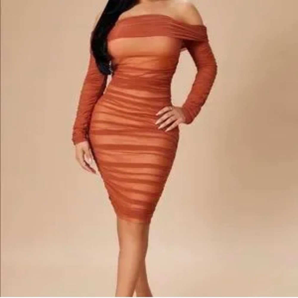 Ready in A ruched off shoulder midi dress.
